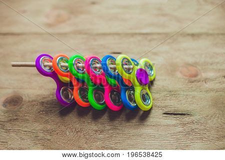 Colored Fidget Spinners Stress Relieving Toy On Wooden Background