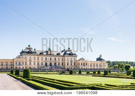 View over Drottningholm Palace and park on a sunny summer day. Home residence of the Swedish royal family. Famous landmark and tourist destination in Stockholm Sweden