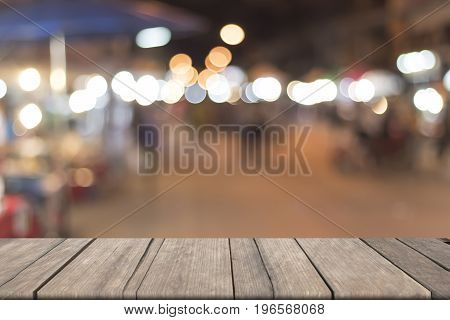 Blurred walking streen with circle of bokeh and vintage wooden on font. mock up