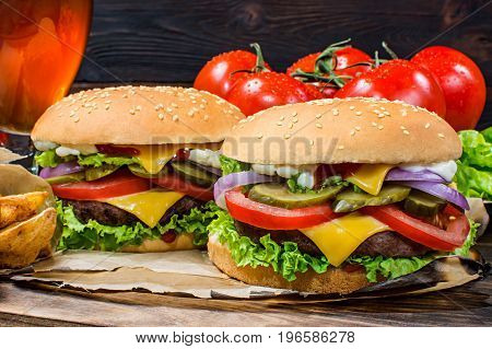 Hamburger and light beer on a pub background