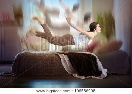 Sleep paralysis concept. Young woman having dream about falling