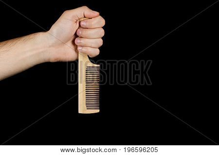 The Fist Wooden Comb Inverted Tooth Down, Isolated On Black Background