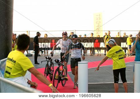 NICE - JULY 27 2017 : IRONMAN Nice 2017. Frederic LIMOUSIN (17) and Cameron WURF (9) finishing the swimming and starting for the 180 km bike tour