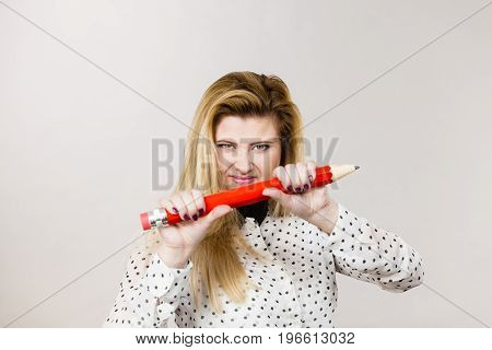 Angry Woman Holds Big Pencil In Hand