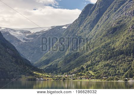 Norwegian fjord landscape with mountains and village. Sorfjorden. Norway. Horizontal