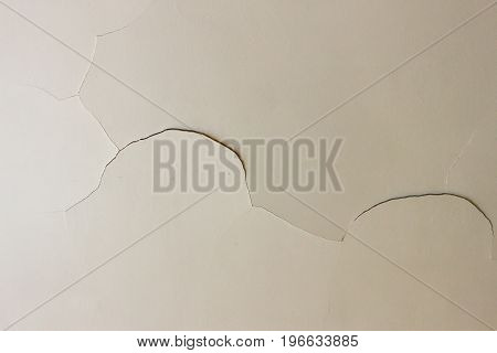 Closeup on a crack in a white ceiling of a generic unidentified old house