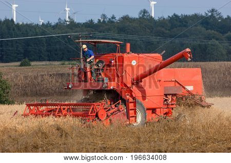 WEST POMERANIAN / POLAND: Harvester in the field during the harvest