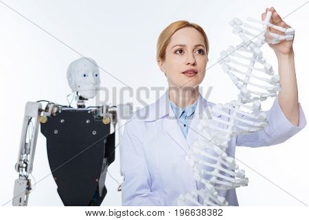 Innovative approach. Unconventional open minded stunning scientist studying how genetics and robotics influencing each other while working in progressive lab