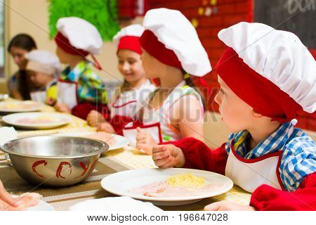 Alchevsk, Ukraine - July 23, 2017: School Cook For Children. Meat Rolls With Cheese Are Prepared.