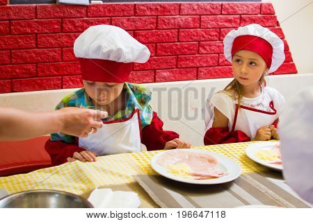 Alchevsk, Ukraine - July 23, 2017: School Cook For Children. Meat Rolls With Cheese Are Prepared.