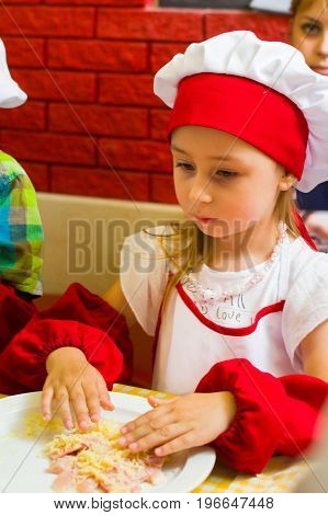 Alchevsk, Ukraine - July 23, 2017: School Cook For Children. Meat Rolls With Cheese Are Prepared.