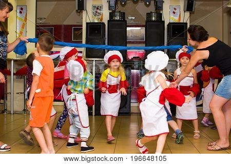 Alchevsk, Ukraine - July 23, 2017: School cook for children. Active games with children in the form of cooks.
