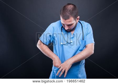 Portrait Of Doctor With Stethoscope Looking In His Pocket