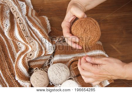 Knitting from natural wool closeup of the hands