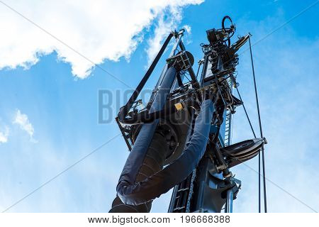 Hydraulic drilling rig in sky with clouds