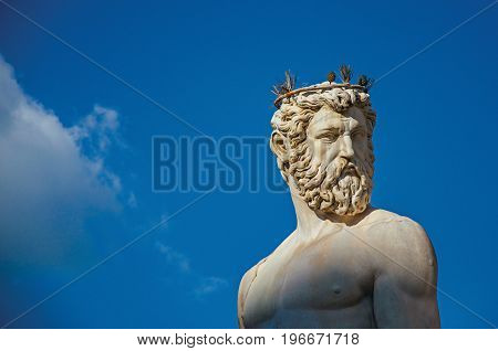 Close-up of marble head of statue in Fontana del Nettuno (Neptune fountain) at sunset. In the city of Florence, the famous and amazing capital of the Italian Renaissance. Located in the Tuscany region