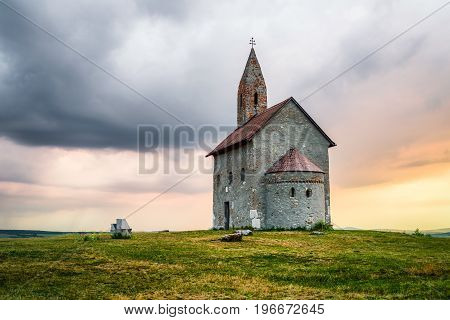 Lonely Drazovsky church in the country and dramatic colorful sky.