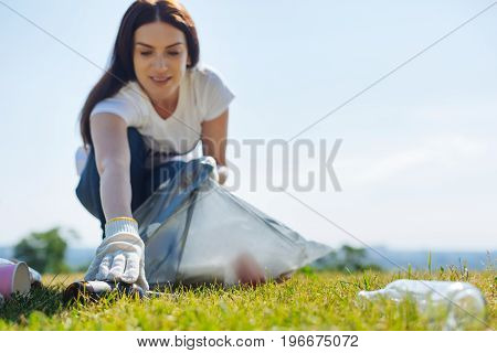 No litter allowed in here. Stunning delicate devoted lady working pro bon while cleaning the lawn from rubbish and improving the environment