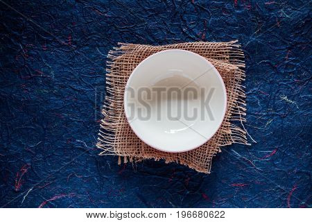 Ceramic of bowl on the blue background.
