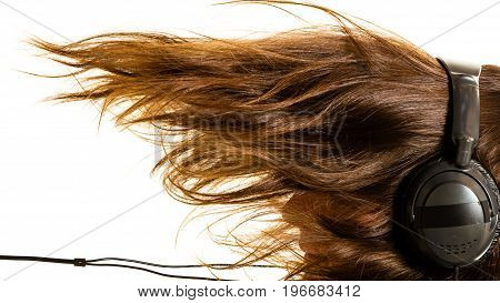 Music devices digital sound concept. Man listening to music on headphones windblown long hair