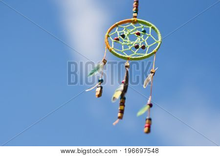 Dream catcher in the wind against the sky