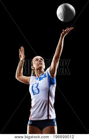 Female professional volleyball player isolated on black background