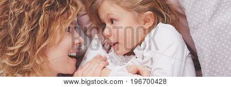 Mother Telling Story To Daughter