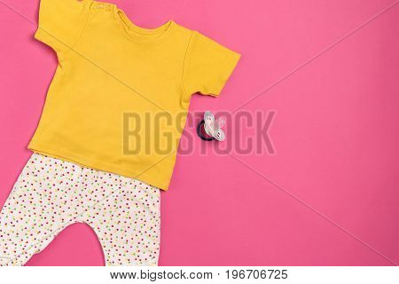 Baby clothes and accessories on pink background. Top view. Copy space. Still life. Flat lay