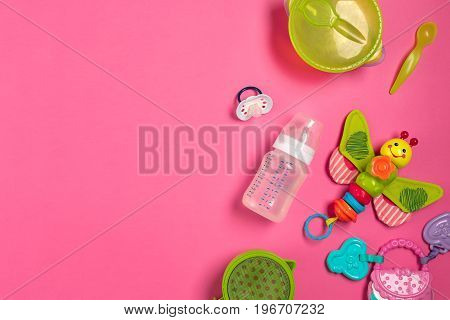 Baby toys and accessories on pink background. Top view. Copy space. Still life. Flat lay