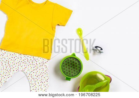 Baby clothes and accessories on white background. Top view. Copy space. Still life. Flat lay