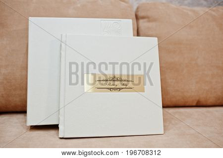Sohisticated White Leather Wedding Photobook Or Photo Album With Golden Inscription Standing On The