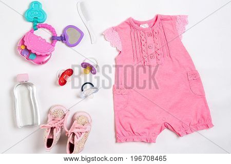 Baby clothes and accessories on white background. Top view. Copy space. Still life. Flat lay