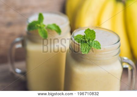 Banana Smoothies And Bananas On An Old Wooden Background