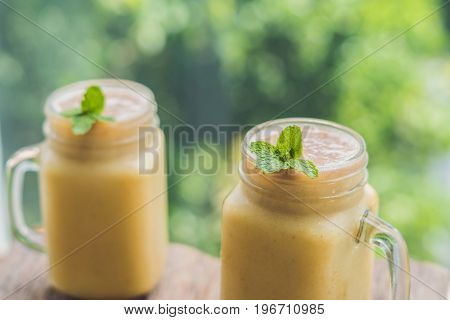Banana Smoothies And Bananas On An Old Wooden Background