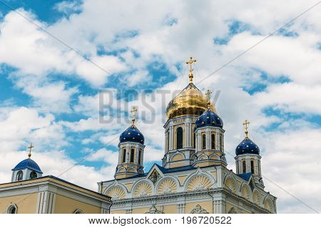 Orthodox crosses on gold and blue domes against blue sky and clouds - Yelets, Russia