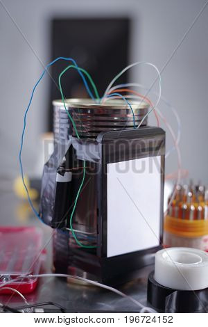 Close up of an improvised homemade bomb explosive device in blurred background.