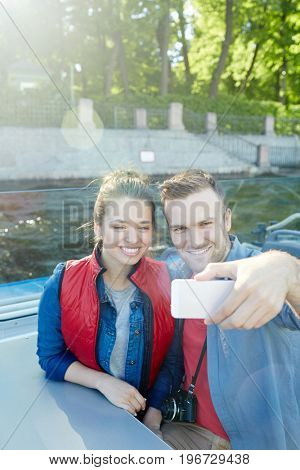 Guy and girl photographing during romantic journey on weekend