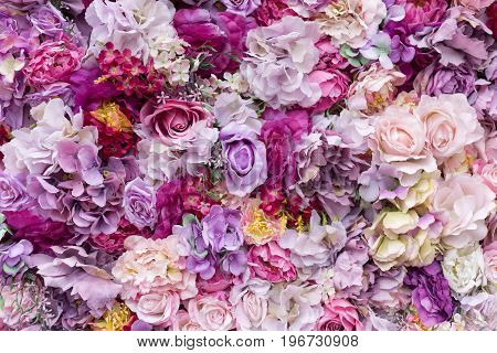 Flower texture background for wedding scene. Roses, peonies and hydrangeas, artificial flowers on the wall