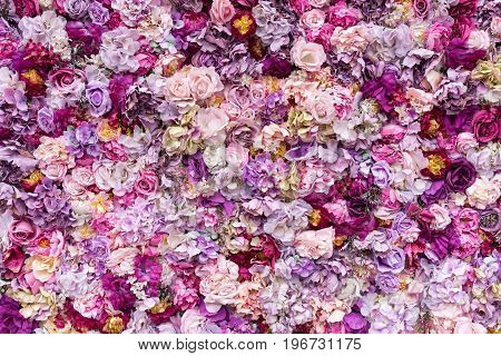Flower texture background for wedding scene. Roses, peonies and hydrangeas, artificial flowers on the wall