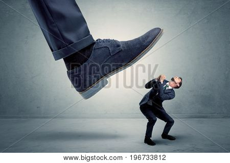 Demoralised employee symbolized by small man getting trampled