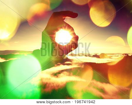 Film Effect. Man Hand Touch Sun. Misty Daybreak In A Beautiful Hills. Peaks Of Hills Are Sticking Ou