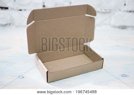Open cardboard box on table