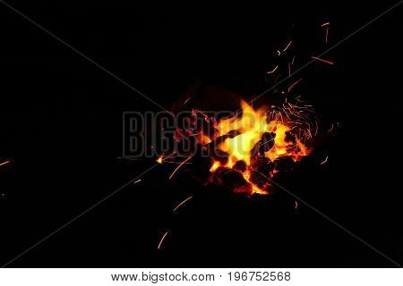 Hot sparking live-coals burning in a barbecue