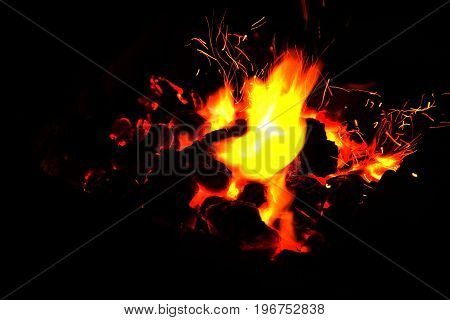 Hot sparking live-coals burning in a barbecue
