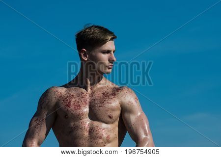 Man with muscular wet body. Adam with glitter on bare chest. Athletic bodybuilder pose as hercules. Sport and workout. Gladiator or atlant.