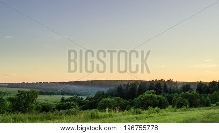 art rural landscape. field and grass forest evening sky
