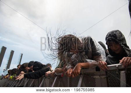 Headbanging Crowd In The First Row At A Hardcore Concert