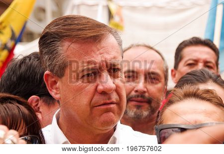 Quito, Ecuador - April 7, 2016: Closeup opposition leader Andres Paez surrounded by people and journalists during anti government protests in Shyris Avenue.