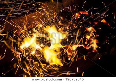 Hot sparking live-coals burning in a barbecue