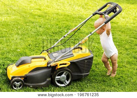 One Year Kid Grinding The Grass With A Grassmower